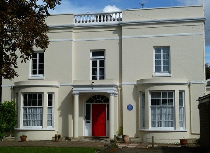 Highcombe House, the Regency villa beside the church, with its blue plaque